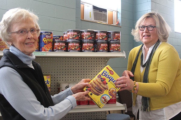 Dorothy Simonsen, left, and Betty Buffington help stock the Ecumenical Food Pantry. – Tiffany Krupke/Albert Lea Tribune