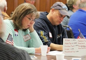 Two people at the Freeborn County Republican Party Convention look at forms for choosing candidates Saturday at the Albert Lea American Legion Club. – Sarah Stultz/Albert Lea Tribune