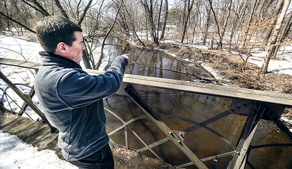 Resource specialist for the Cedar River Watershed District, points out points along  Dobbins Creek where steps have been taken to ease shore erosion. The CRWD has been awarded a $1.5 million grant improve Dobbins water quality. – Eric Johnson/Austin Daily Herald