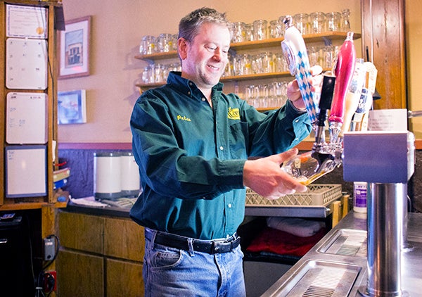Peter Ausenhus, co-owner of Worth Brewing Company in Northwood, pulls a beer in his taproom. Ausenhus and his wife have owned and operated the brewery for seven years. – Colleen Harrison/Albert Lea Tribune