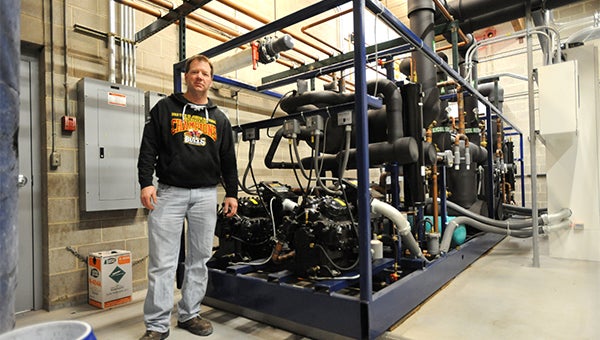 Jim Osmundson, the facilities maintenance supervisor at Albert Lea City Arena, stands next to the Copeland compressor and Rinktech refridgeration system for the main ice sheet at the arena. Because of the installation of the system five years ago, Albert Lea City Arena will not be affected when the R-22 coolant is phased out. — Micah Bader/Albert Lea Tribune