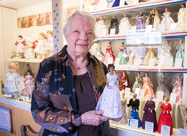 Elaine Ausen Seath holds her most recent doll, first lady Michelle Obama, in front of her display case inside of her Freeborn home. Seath has made dolls of every first lady that’s attended an inauguration, a 40-year-long project that she just recently finished in February. – Colleen Harrison/Albert Lea Tribune