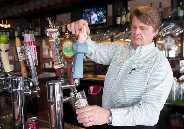 Green Mill Restaurant & Bar General Manager David Mord pulls a beer from Third Street Brewhouse in Green Mill’s bar area. Green Mill has 24 taps, 16 of which contain craft beer. Mord, a homebrewer of 25 years and a craft beer enthusiast, has been instrumental in bringing more craft beer selections to the Albert Lea establishment. – Colleen Harrison/Albert Lea Tribune