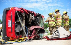 Firefighters Trevor DeRaad, Kurt Wallace and Jordan DeVries discuss the stabilization of a flipped Ford Escape during an extracation training last June in Albert Lea at Allen’s Tow-N-Travel. The firefighters used the Escape to practice multiple rescue scenarios. – Brandi Hagen/Albert Lea Tribune
