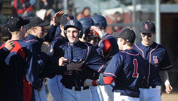 Trevor Stencel of United South Central is congratulated by his teammates after hitting a two-run homer in the top of the third inning Thursday at NRHEG. USC won 8-1. — Micah Bader/Albert Lea Tribune
