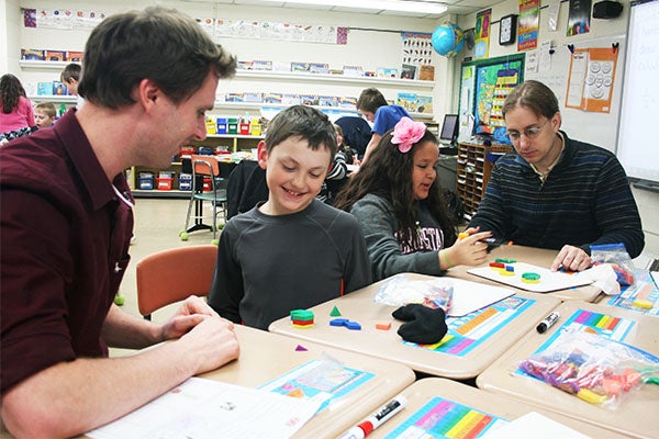 David Goodchild, left, a teacher from the United Kingdom, works with William Haukoos Tuesday at Lakeview Elementary School, while fourth-grade teacher Mark Nechanicky, right, works with Abby Romo. Goodchild is visiting Albert Lea schools this week.  – Sarah Stultz/Albert Lea Tribune