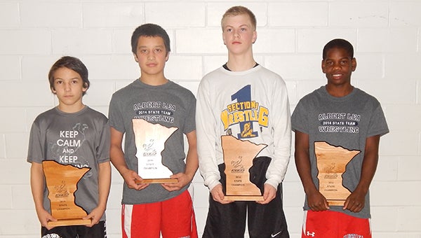 Members of the Albert Lea junior high wrestling team stand in Rochester with their trophies after the National Youth Wrestling Association’s state meet. From left are Nic Cantu, Jessie Hernandez, Gavin Ignaszewski and Joseph Peterson, who were all state champions. — Submitted