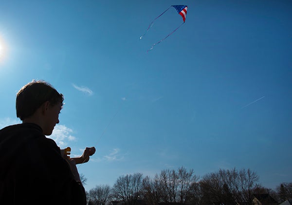 Alec Wendleboe, 14, flies a kite Friday afternoon off of West Front Street in Albert Lea. Wendleboe said he flies kites a lot once the weather’s nice enough and said his American flag kite is his favorite. “I like how high it can go.” – Colleen Harrison/Albert Lea Tribune