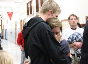 Alyssa Drescher wipes away a tear Thursday night in the hallway of United South Central School after finding out she would be expelled for the rest of the school year. -- Sarah Stultz/Albert Lea Tribune    