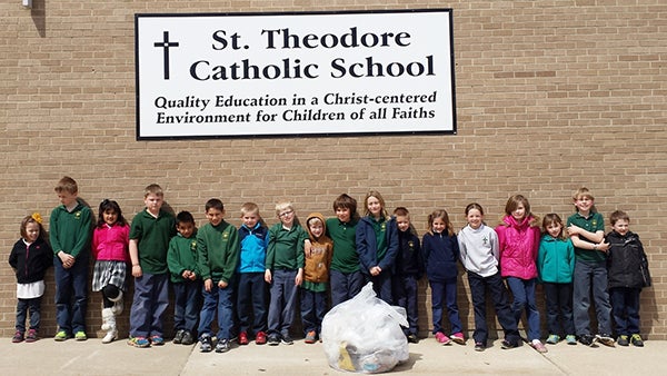 St. Theodore Catholic School students pick up litter around the school on Earth Day. – Submitted