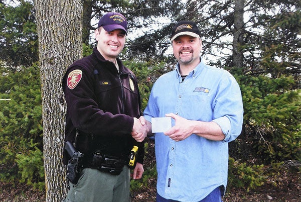 Scott F. Peterson, right, was awarded the specially-marked Department of Natural Resources 10-year Volunteer ATV Safety Instructor Award by conservation officer Brent Ihnen April 26 at the ATV safety class in Clarks Grove. – Submitted