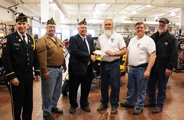 Roger Bakken, American Legion Post 56 commander, presents R.J. Bergstrom, flagbearer for the 2014 Nation of Patriots local group, a check for $807 raised at a flea market in March. The funds will go to provide financial support to veterans. Pictured from left are David Olson, American Legion chaplain; John Severtson, Beyond the Yellow Ribbon chairman; Bakken; Bergstrom; Mark Harig with the Nation of Patriots and Duane Bergdale, part owner of Bergdale’s Harley-Davidson. During the Nation of Patriots tour, motorcycle riders escort the American flag through 48 states. Local riders will welcome the flag to to Albert Lea Aug. 26 and then leave the city at 9 a.m. Aug. 27 to travel to Waukon, Iowa. – Sarah Stultz