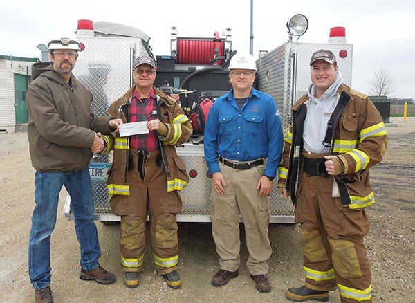 Wayne Rankin and Tim Lewis of Alliance Pipeline present a donation of $5000 to Steve and Sean Kraushaar of the Myrtle Fire Department. The donation will help with the purchase of a new slide in pump and tank unit for the department’s grass and brush fire truck. The donation was made possible through the Alliance Pipeline Community Investment program. – Submitted