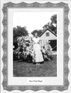 A photo of Lang’s mother, Fern Twito Hegel, standing in front of her favorite bush, bridal wreath spirea.