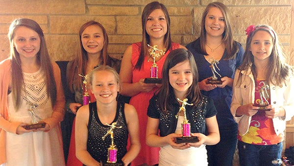 Members of the Albert Lea Figure Skating Club stand with trophies last Sunday at an awards banquet. Front row from left are Dani Helland and Makenzie VanderSyde. Back row from left are Kailey Christensen, Carine Rofshus, Cammy Tewes, Nikki Bos and Evy Christensen. — Provided
