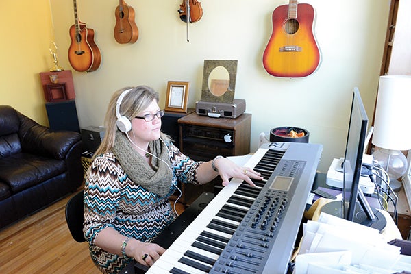 Musician Jennifer Ordalen practices a song in her home.