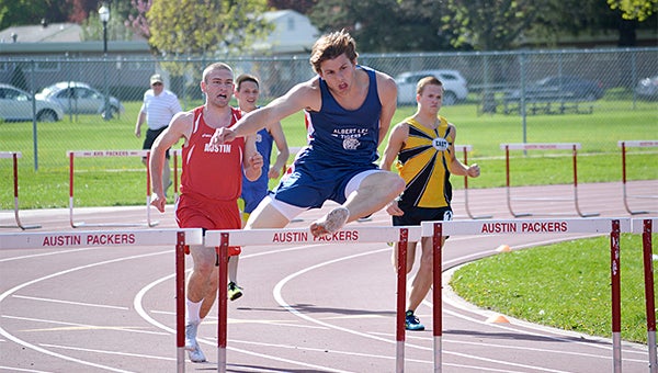 Preston Smith of Albert Lea leaps during the 300-meter hurdles Friday at the Big Nine Conference Tournament at Austin. Smith set a new personal-best time of 40.67 seconds to win the event and give him All-Conference honors. — Lon Nelson/for the Albert Lea Tribune