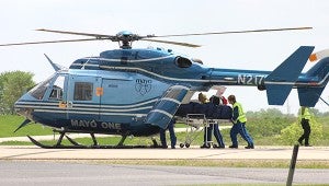 Mayo One first responders lift an injured man into a helicopter after a crash Friday afternoon near the intersection of Interstate 35 and Freeborn County Road 46. — Sarah Stultz/Albert Lea Tribune
