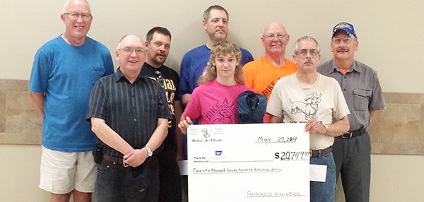 Participants from the Freeborn County Bike-A-Thon hold a check for $20,749 that was donated to the American Cancer Society for cancer research. Cyclists raised the money before the event. Front row, from left, are Richard Diaz, Jacob Moffitt and William Bartholmey, who represented his daughter, Jen Kahler. Back row, from left, are Don Munden, Leon Bure, David Anderson — who raised the most money, $3,131 — Glen Juveland and Chuck Sandager. – Provided
