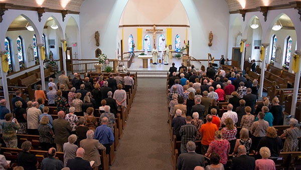 The Rev. Timothy Reker and Deacon Mike Ellis officiate Paul Sparks' memorial service Friday at St. Theodore Catholic Church in Albert Lea. Sparks died June 3 after battling cancer. — Colleen Harrison/Albert Lea Tribune