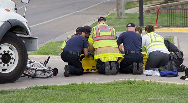 First responders from the Albert Lea Fire Department, Gold Cross Ambulance and Albert Lea Police Department assist Sandra Nash onto a stretcher Tuesday at the Kwik Trip near Front Street and First Avenue in Albert Lea. She was taken to Mayo Clinic Health System in Albert Lea. – Tim Engstrom/Albert Lea Tribune