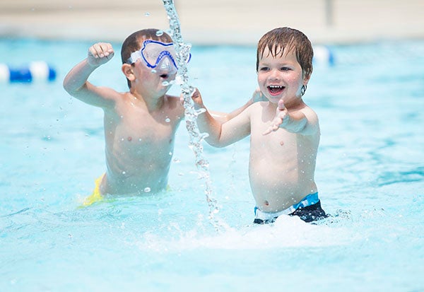 Bradley Borchert, 3, right, and Gage Rodriguez, 5, play in the children’s area of the Albert Lea city pool Tuesday. The pool opened for the season Saturday. – Colleen Harrison/Albert Lea Tribune