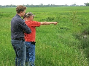 Farmer Jared Nordick explains a water runoff issue to Minnesota Department of Agriculture officials on June 11, 2014 near Rothsay. – Dan Gunderson/MPR News