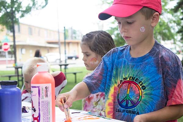 Noah Teeter works on his painting at Kids Art in the Park Wednesday. – Hannah Dillon/Albert Lea Tribune
