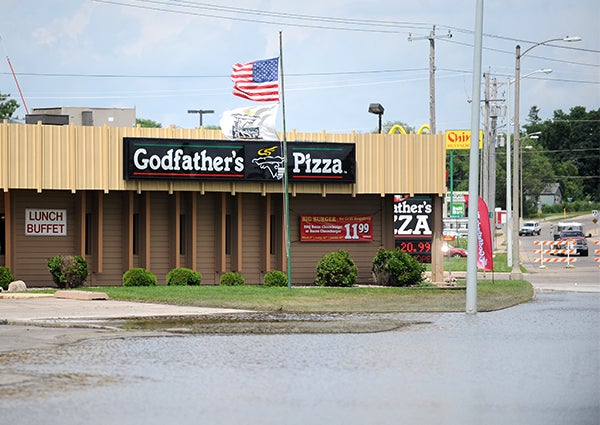 Godfather's Pizza is open Thursday despite flooding in the section of main street in front of it. — Jacob Tellers/Albert Lea Tribune