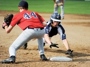 Albert Lea's Jake Kilby dives back into first base on a pick-off attempt before Austin' Alex Ciola can get the tag down during VFW baseball action Wednesday afternoon in Austin. —  Eric Johnson/Albert Lea Tribune