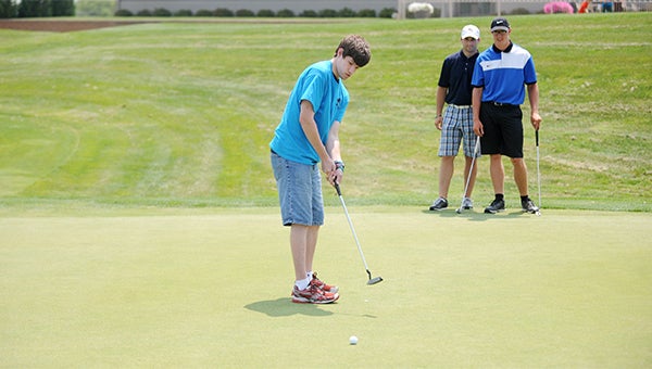 Taylor Shaft puts for golfers on hole No. 9 during the 39th annual Sparky Dan Kruse Memorial Golf Classic at Wedgewood Cove Golf Club. — Jacob Tellers/Albert Lea Tribune