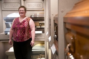 Sue Nasinec stands in a showroom of the Bruss-Heitner Funeral Homes location in Wells. Nasinec has been a mortician for almost 20 years, and is currently licensed in both Minnesota and Iowa. – Colleen Harrison/Albert Lea Tribune