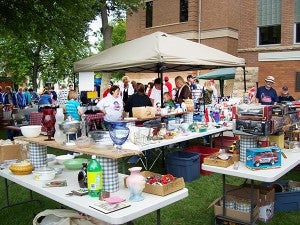 People scrounge through rummage sale goods at Puckerbrush Days in Forest City.