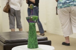 Andrea Blackmor’s “Totem” stands among the visitors to the Freeborn County Arts Initiative’s first show and open house on Wednesday. – Hannah Dillon/Albert Lea Tribune