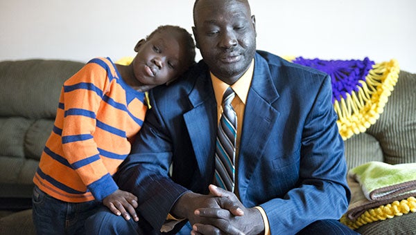 Dabang Gach, pictured with his son Keat Ruot, 5, fled South Sudan when he was 15 due to the civil war. He, along with many others, traveled on foot to a refugee camp in Ethiopia. Gach said it’s important to him that his children know their history and know what their parents experienced to give them a life in the United States. -- Colleen Harrison/Albert Lea Tribune