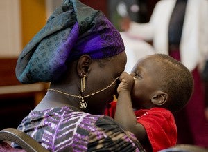A child plays with his mother during a Sudanese worship service Sunday at First Presbyterian Church. – Colleen Harrison/Albert Lea Tribune