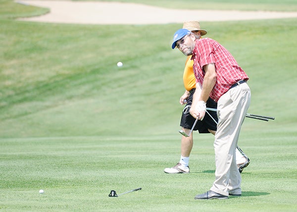 Lonny Hagen chips the ball onto the green Monday in the 51st annual Albert Lea-Freeborn County Chamber of Commerce Ambassador Scholarship Golf Outing held at Wedgewood Cove Golf Club. –  Jacob Tellers/Albert Lea Tribune