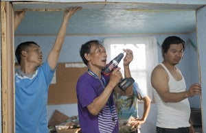 From left, Htoo Gax Wol, Mello Saw and Ka De work on opening up a room in a trailer the local Karen community uses for meetings and worship services. The community has no other central location to meet at, something they hope will change as plans for a possible resource center in Albert Lea are discussed. – Colleen Harrison/Albert Lea Tribune