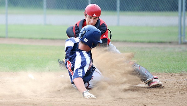 The Albert Lea VFW baseball team’s Sam Moyer slides while Austin’s catcher attempts to block the plate Saturday during the district tournament at Marcusen Park in Austin. — Micah Bader/Albert Lea Tribune