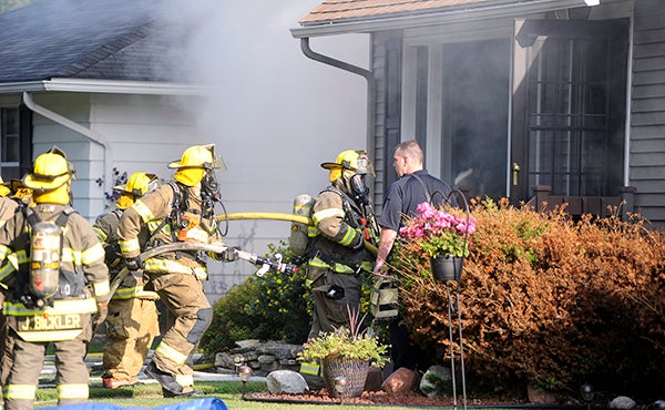 Austin Fire Chief James McCoy directs firefighters through the front door at the home of Mayor Tom Stiehm Friday morning. — Eric Johnson/Albert Lea Tribune