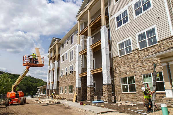 Construction crews work on the facade of River Bend Assisted Living and Memory Care facility in Rochester July 24. – Alex Kolyer/MPR
