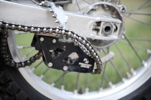 The sprocket of Flategraff’s dirt bike is bent around the swingarm as a result of landing a jump Tuesday at the Motokazie Supercross Series at Austin. — Micah Bader/Albert Lea Tribune