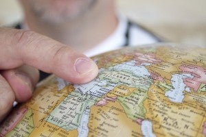 Jerry Bizjak points to the country of Turkey on a globe in his home, a country where he spent two weeks and traveled over 2,000 miles last month. – Hannah Dillon/Albert Lea Tribune