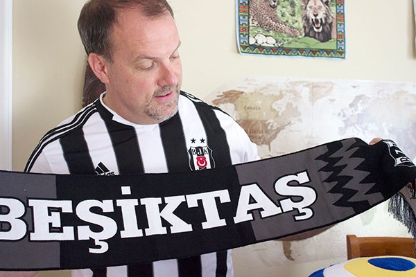 Jerry Bizjak holds a scarf from the Turkish soccer club, Besiktas Jimnastik Kulübü, and wears the club’s jersey. Bizjak said many Turkish people came up and commented on his jersey despite the language barrier. – Hannah Dillon/Albert Lea Tribune