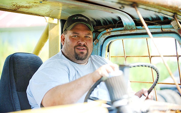 Ryan Linde sits Saturday in his ‘62 Ford truck. The truck has a 360 Chevrolet engine, and Linde took first place with it on Aug. 3 at the Freeborn County Fair’s demolition derby. – Micah Bader/Albert Lea Tribune