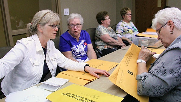 Second Ward election judges Melody Randall and Neva Mathison turn in their election results to Albert Lea City Clerk Shirley Slater-Schulte Tuesday night at the Freeborn County courthouse. — Sarah Stultz/Albert Lea Tribune