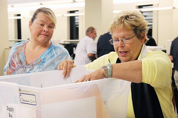 Nancy Cornelius, right, and Jeanne Herman go through the precinct results for the city of Geneva Tuesday night at the Freeborn County Courthouse. – Sarah Stultz/Albert Lea Tribune