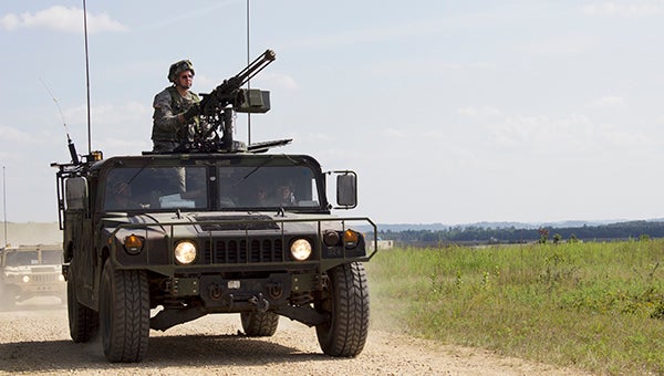 Members of the 2-135 IN Delta Company out of Albert Lea drive a Humvee with a large machine gun mounted on top to a training exercise at Fort McCoy, Wis. See more photos in the Sunday Tribune. – Hannah Dillon/Albert Lea Tribune