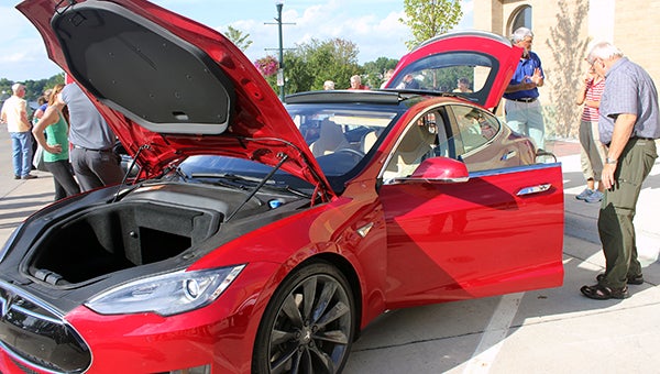 Dave Wolter checks out a Tesla Motors car Wednesday night in downtown Albert Lea. Wolter said he was impressed with the vehicle. – Sarah Stultz/Albert Lea Tribune