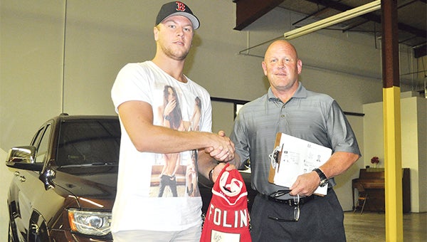 Christian Folin of the Minnesota Wild meets with Steve Moline of Holiday Cars in Austin Thursday. Folin, who used to play with the Austin Bruins, was in town to purchase a vehicle. — Rocky Hulne/Albert Lea Tribune